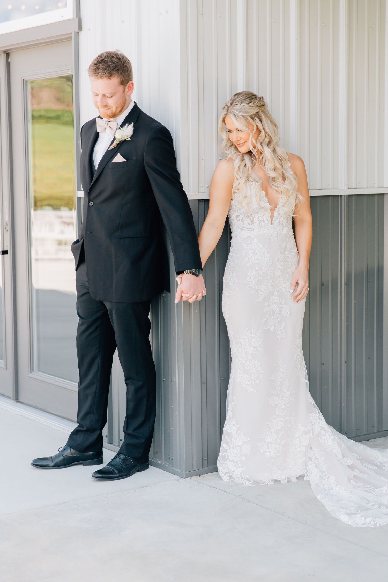 A series of wedding photos showing a bride and groom holding hands around a corner in a first look moment.