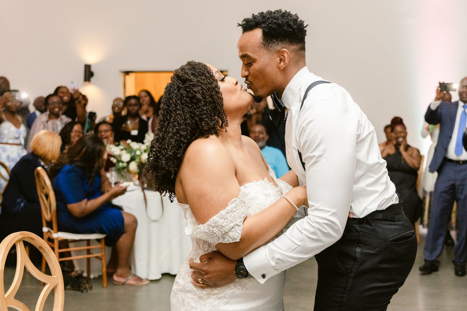 Wedding couples dancing together during romantic reception celebration.