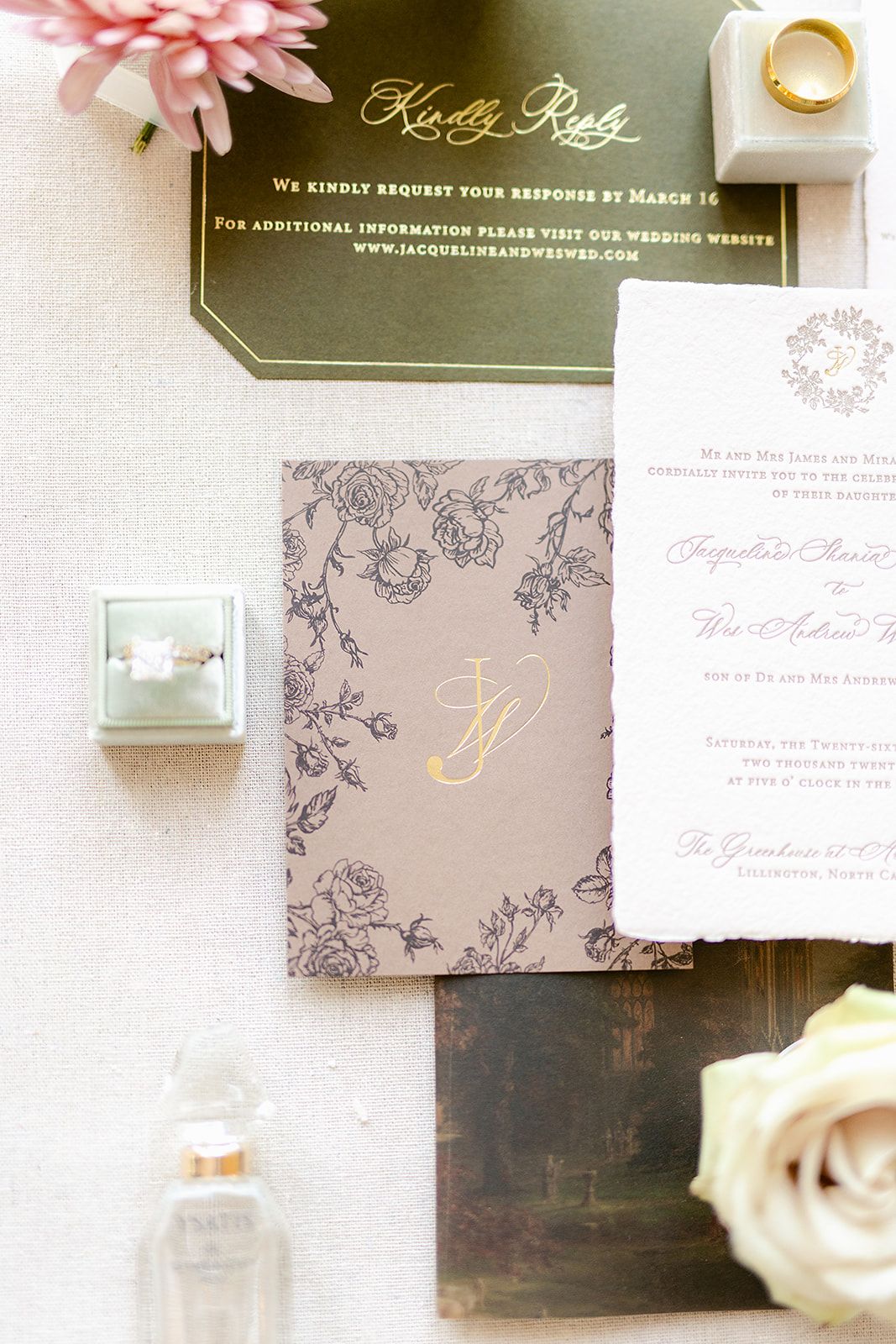 Close-up of wedding stationery with gold foil lettering and blush pink accents on dark and light backgrounds.