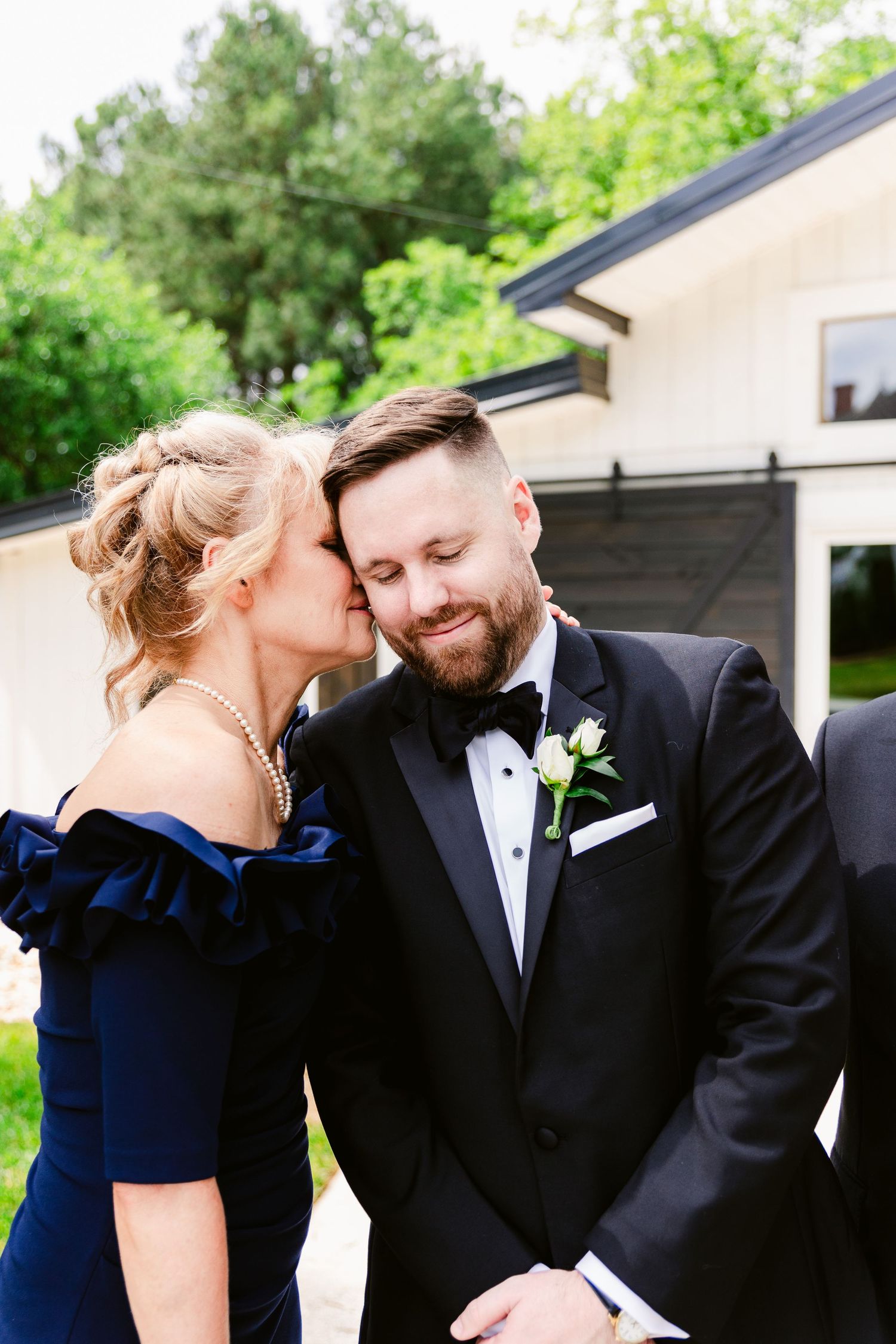 A couple in formal wedding attire shares intimate moments in a series of romantic outdoor photos.
