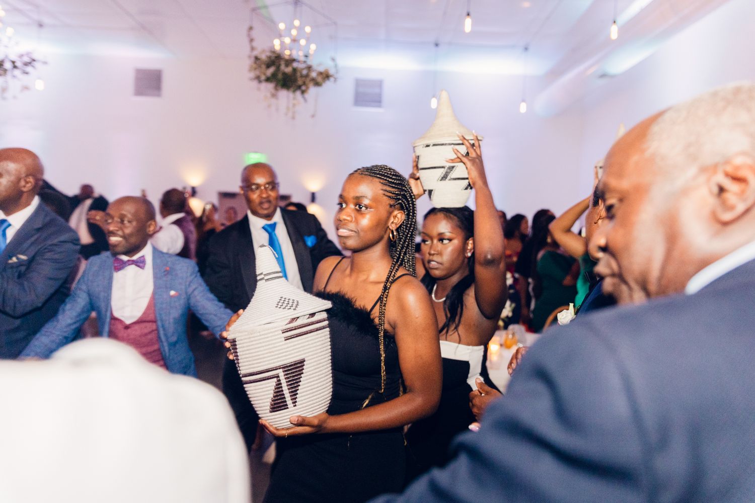 Wedding guests enjoying the dance floor during an indoor evening reception.