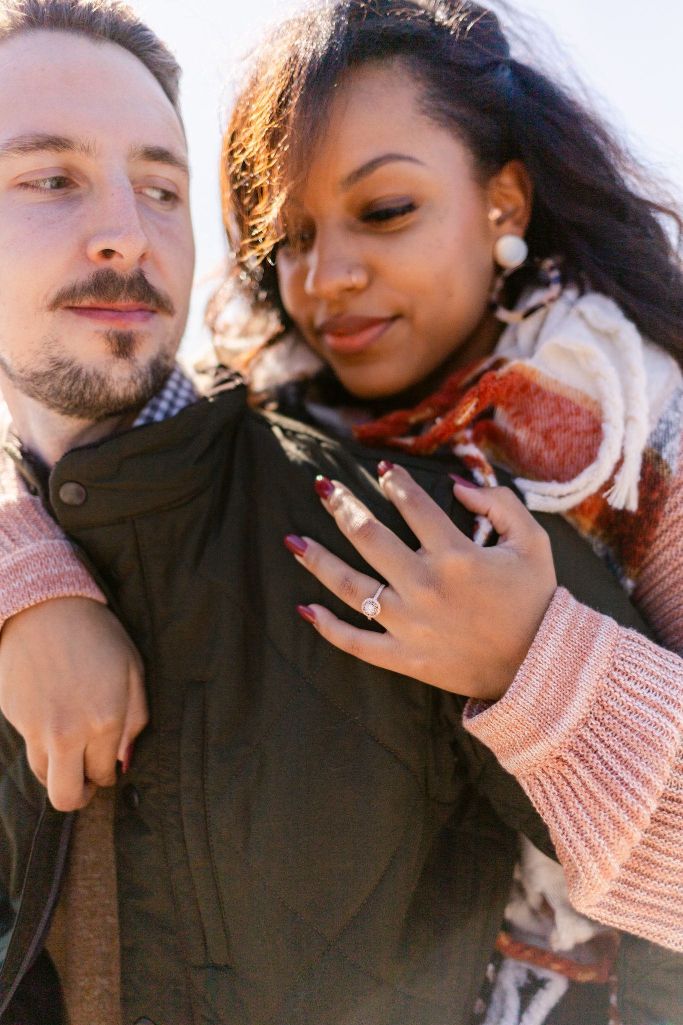 Close-up shots capture tender moments between a couple wearing pink and dark clothing.