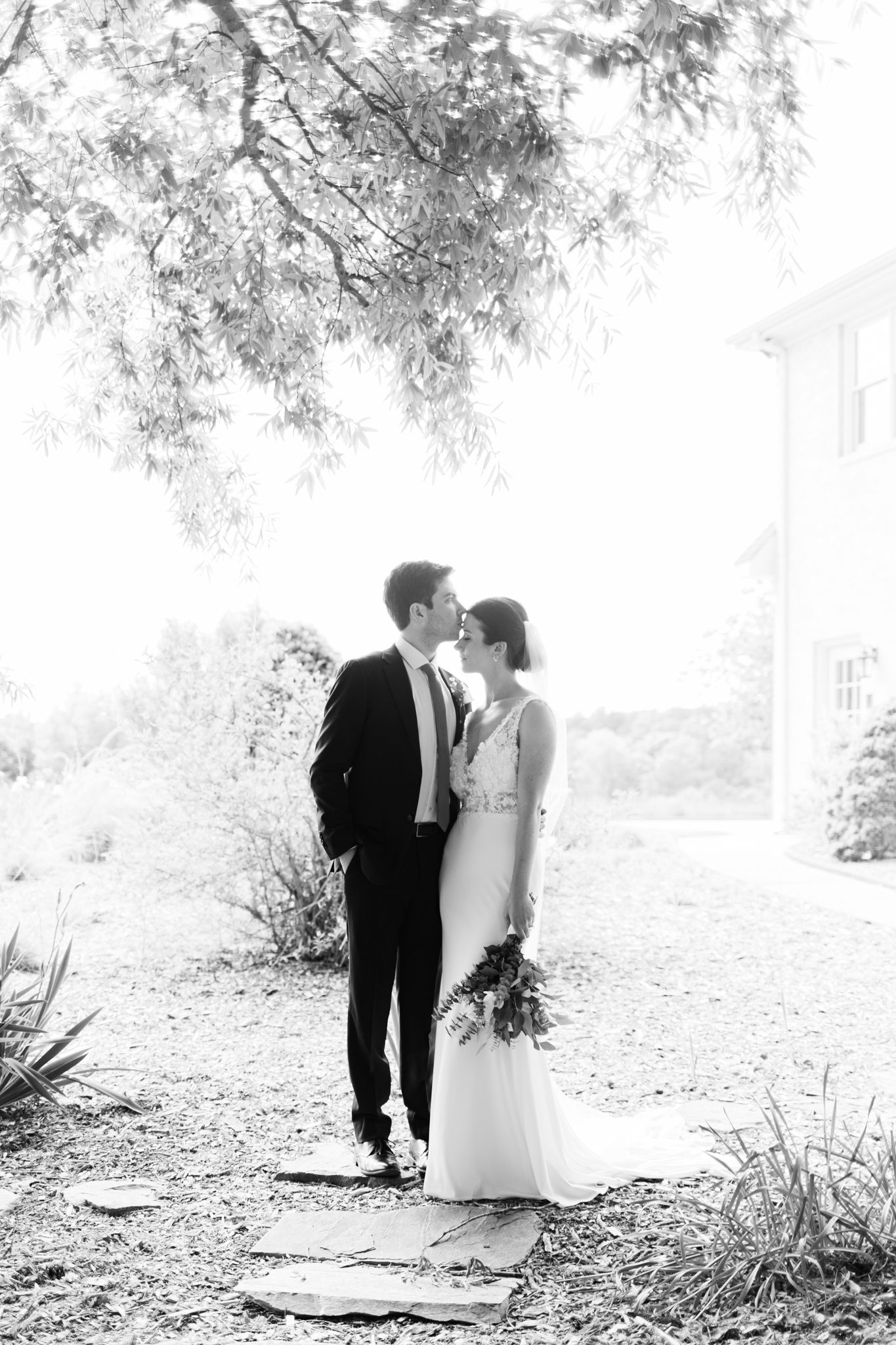 Black and white wedding photography collage showing romantic moments between a couple in an outdoor garden setting.