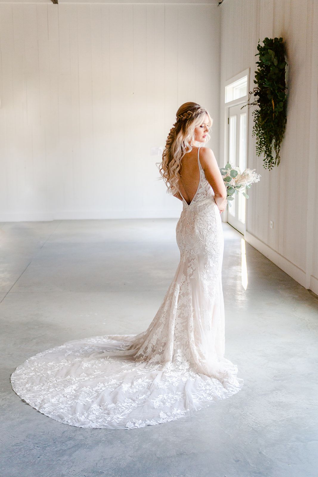 Elegant lace wedding dress with cathedral train shown from multiple angles in a bright white studio setting.