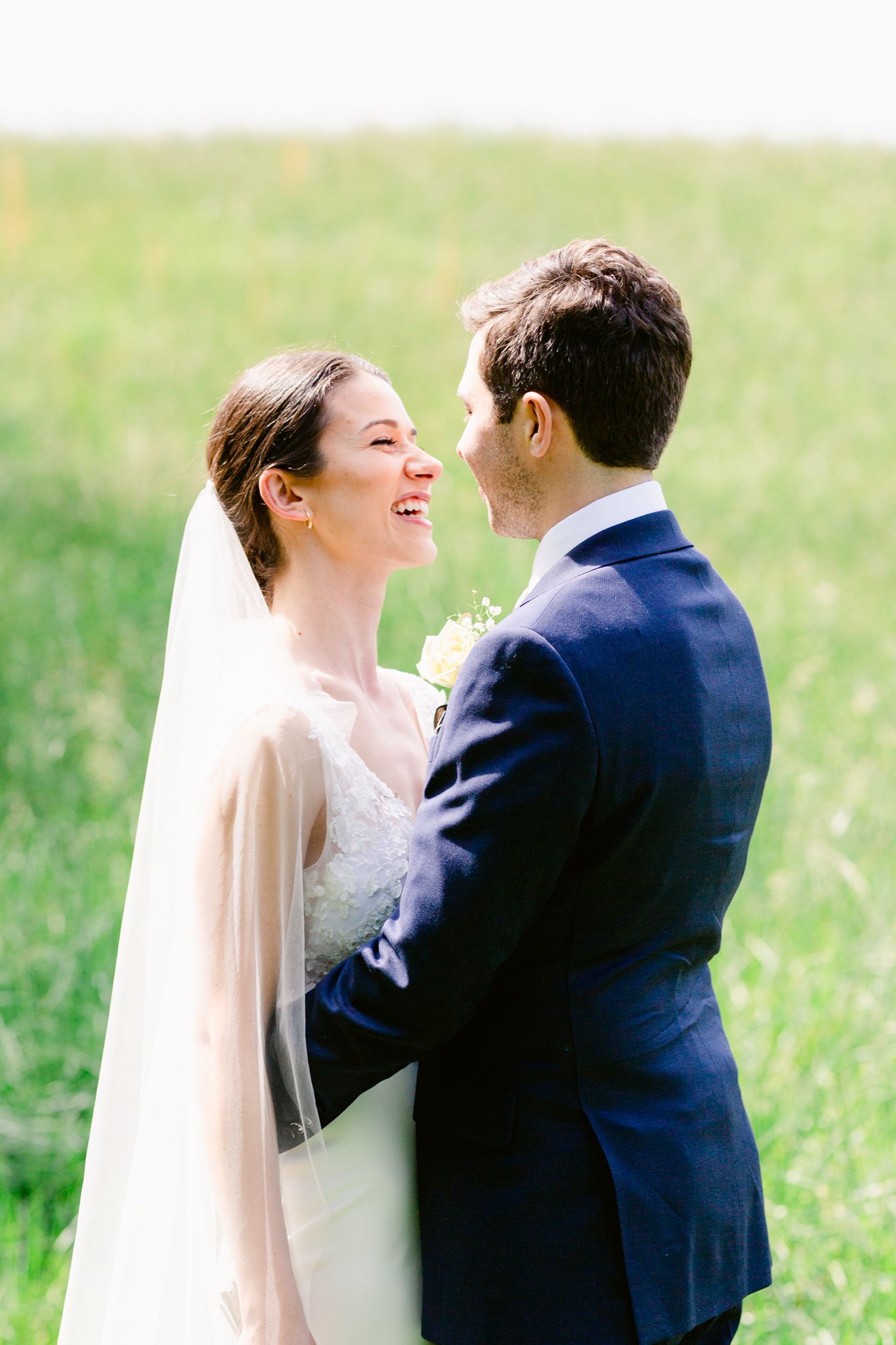 A romantic wedding couple shares joyful laughter in a series of candid moments outdoors.
