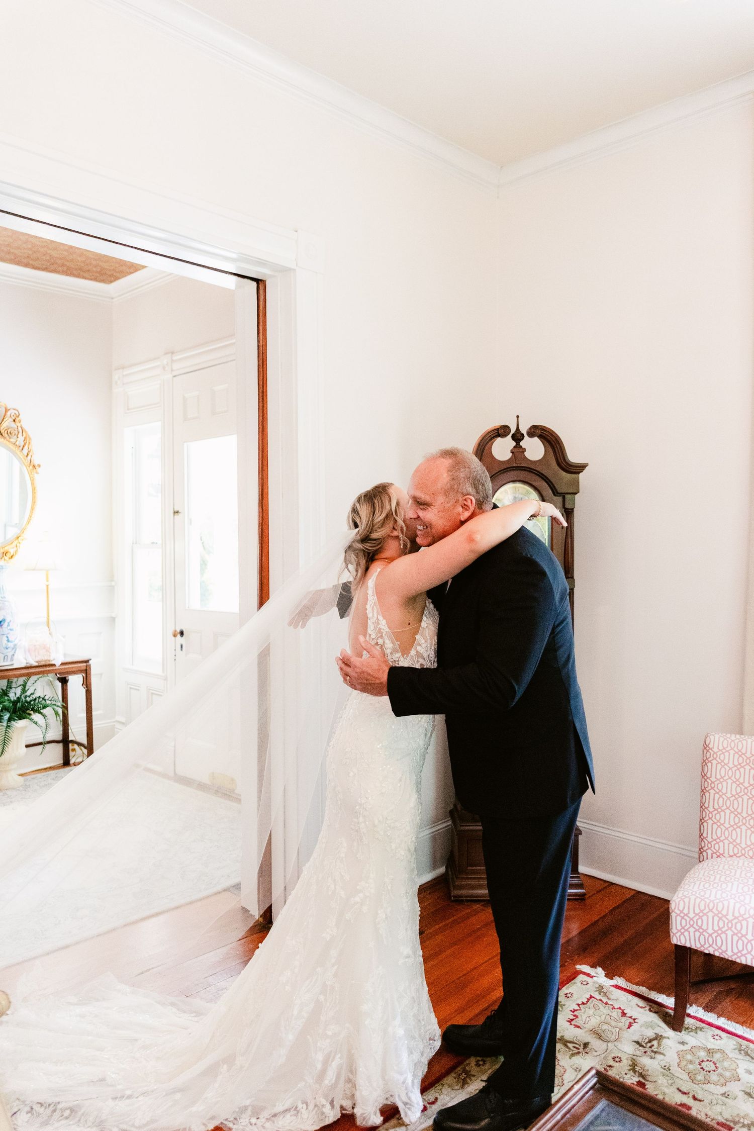 A series of four intimate first-look moments in a bright white room with hardwood floors and floral accents.
