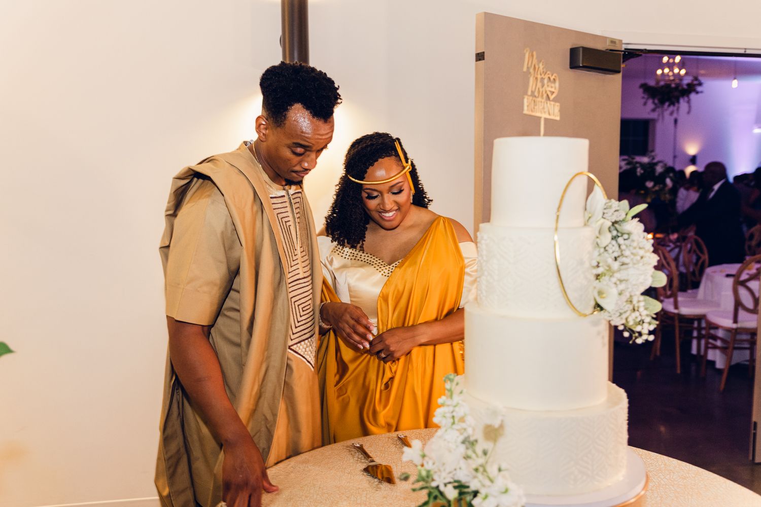 Wedding celebration showing guests in yellow and white attire interacting at the reception.