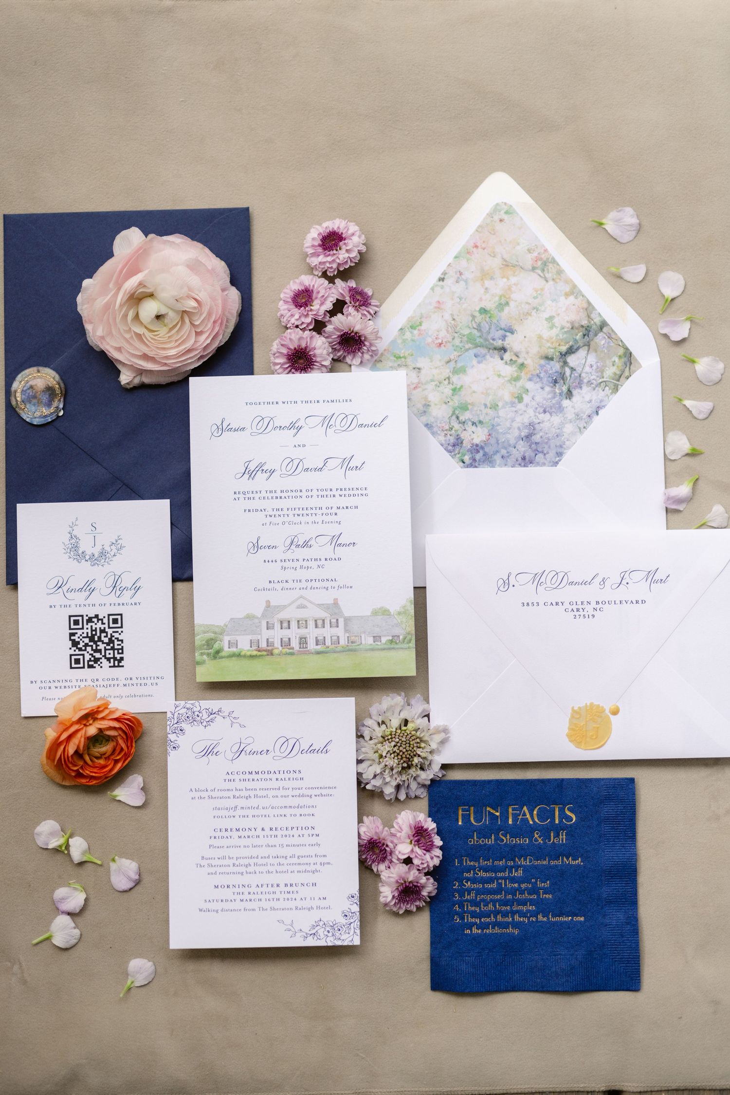 Elegant wedding invitation suite with navy and pink florals, featuring classic calligraphy and floral envelope liner.