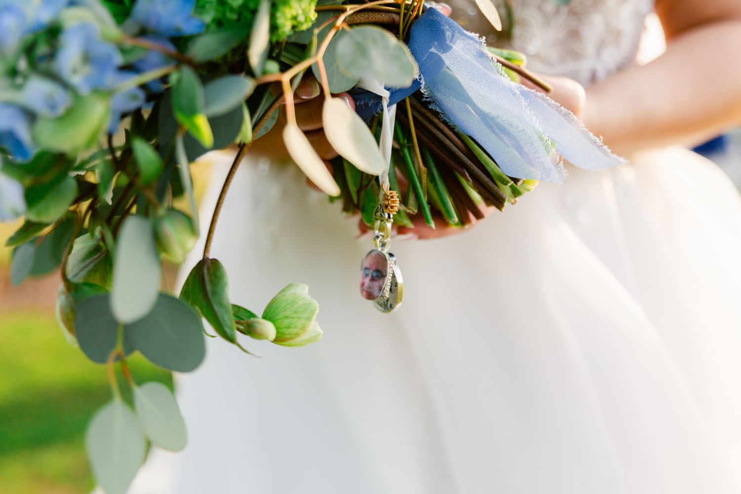 Close-up detail shots of delicate white wedding floral arrangements with greenery against a soft blurred background.