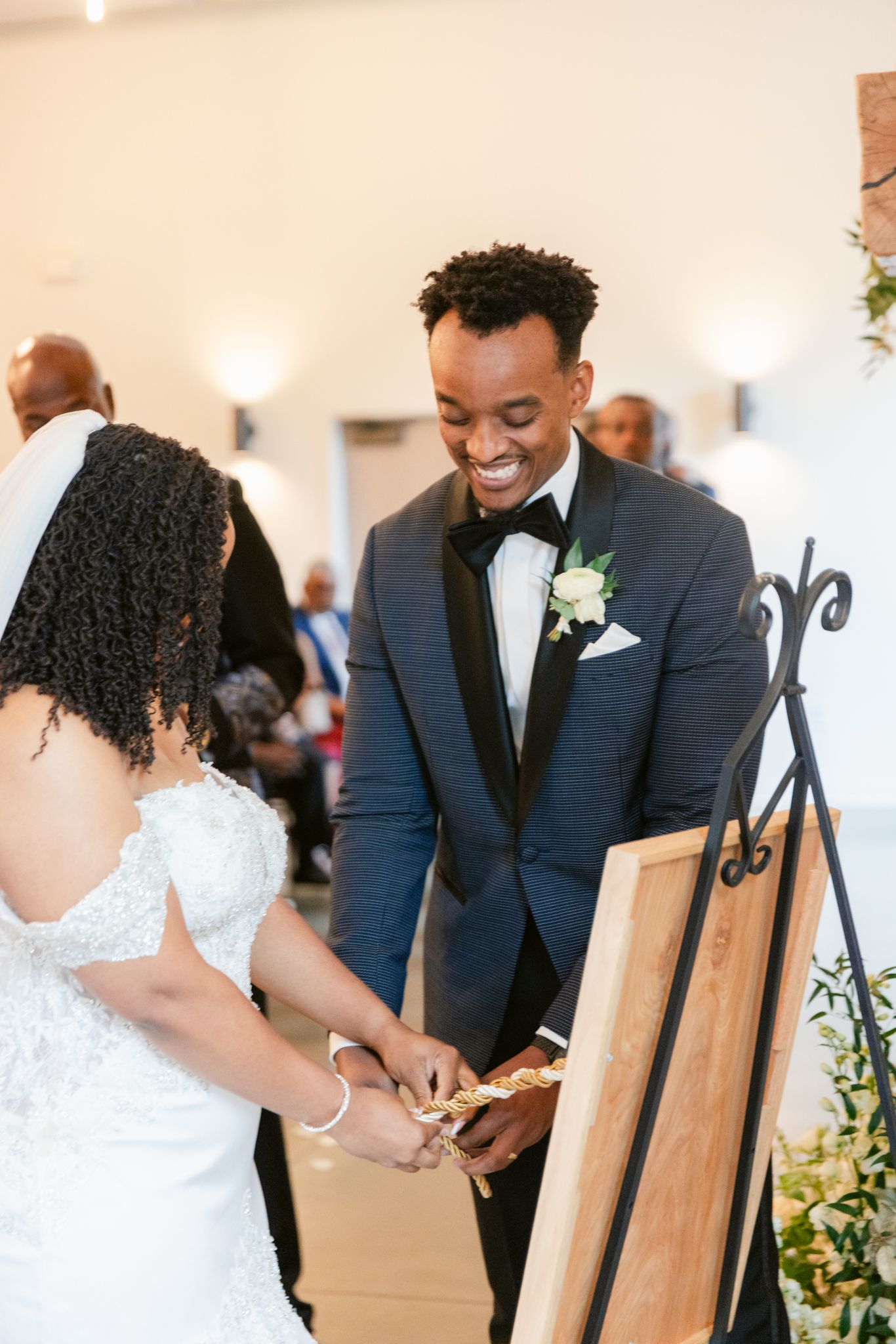 A candid moment during a wedding ceremony showing joy and laughter while signing documents.