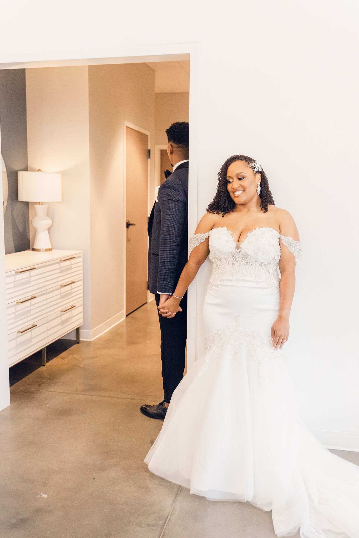 A couple shares a private first look moment before their wedding ceremony, with the bride wearing a beautiful off-shoulder gown.