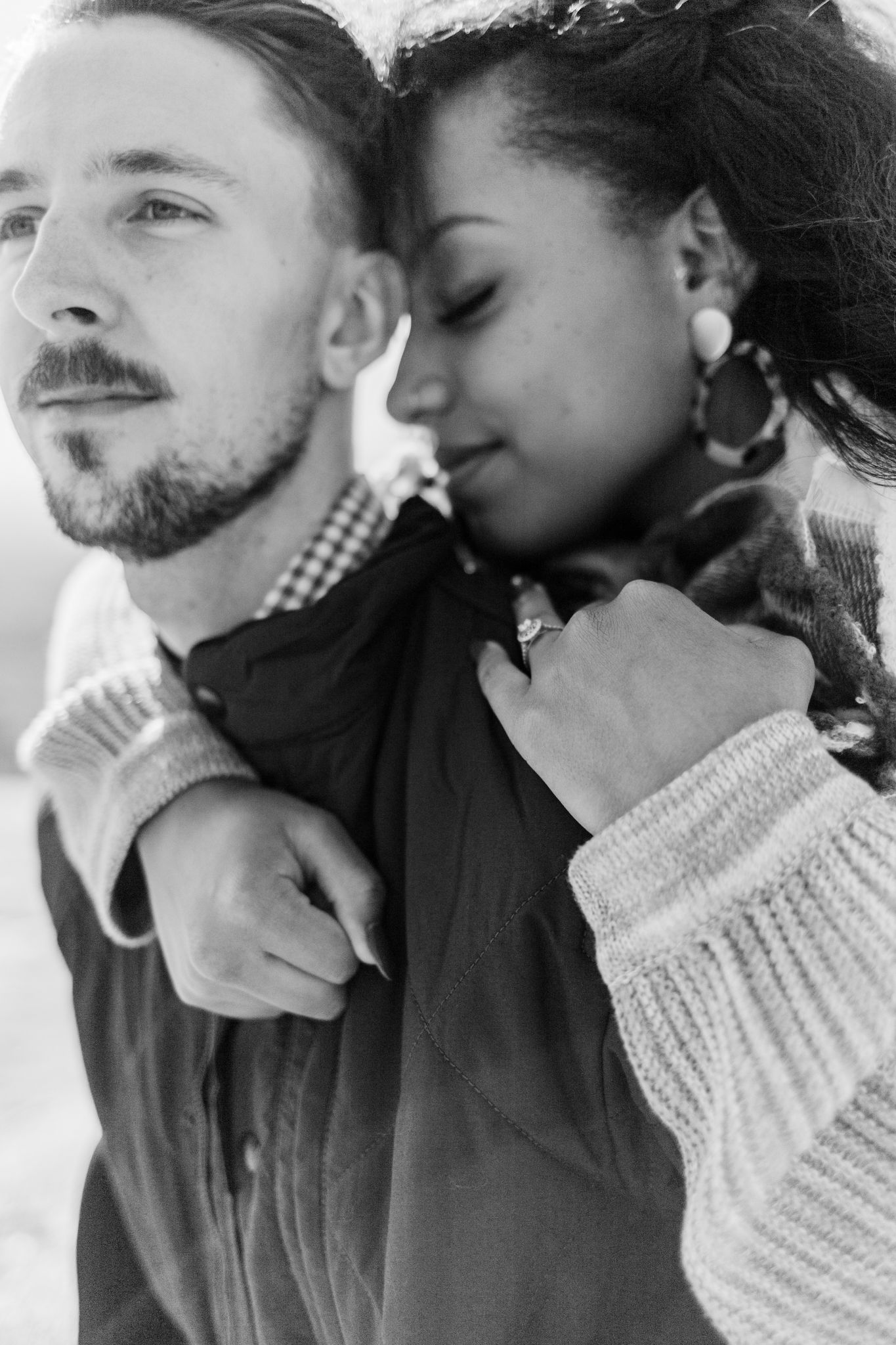 A series of intimate black and white photos showing a couple embracing and sharing tender moments together.