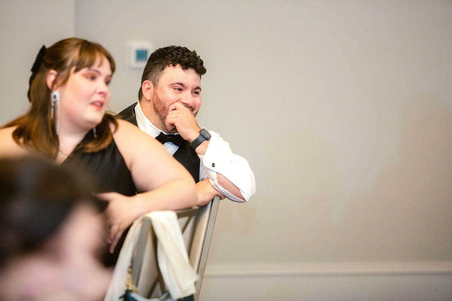 A couple dancing together at a formal event in elegant attire.
