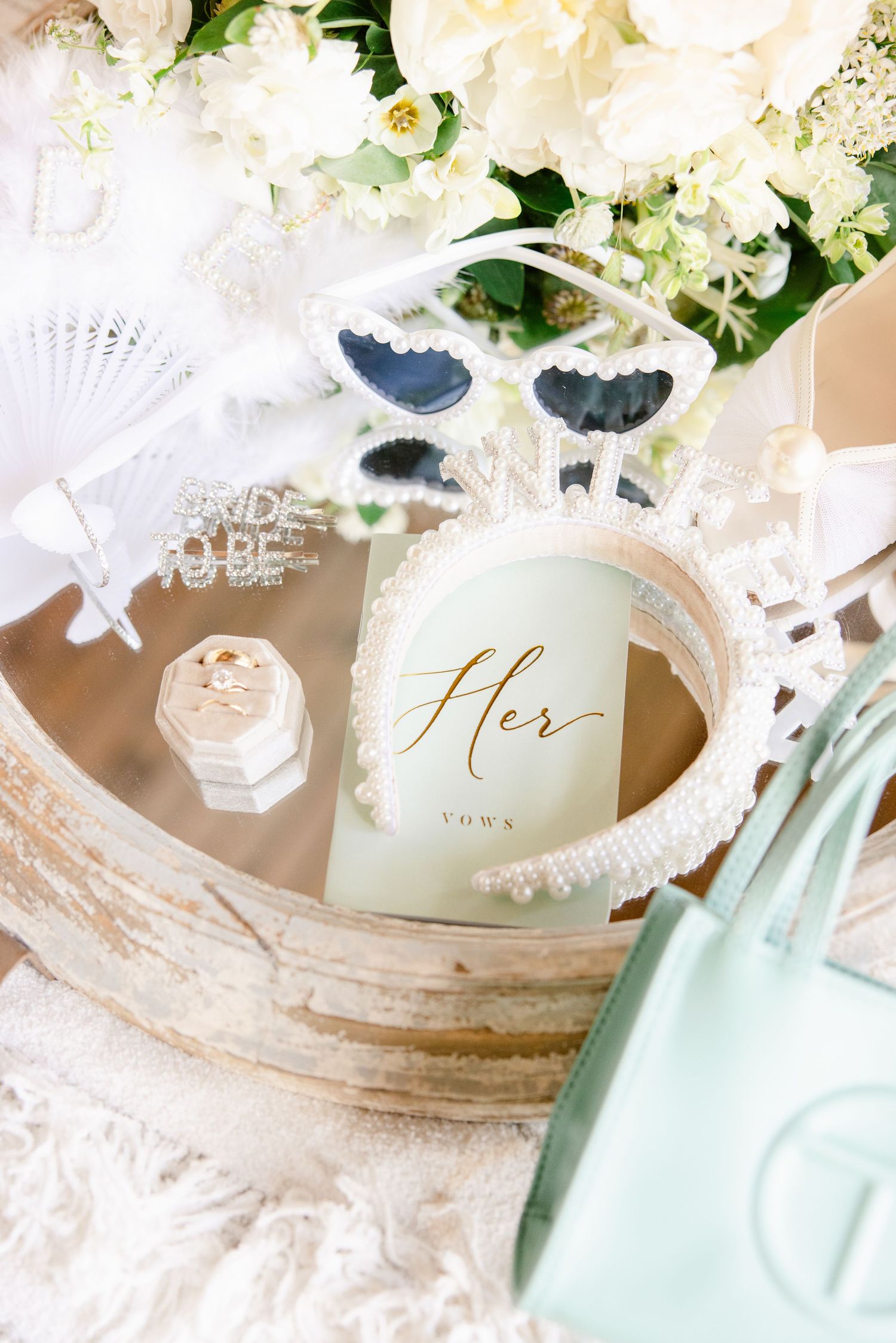 Romantic wedding decor featuring white flowers and delicate lace details with mint green accents.