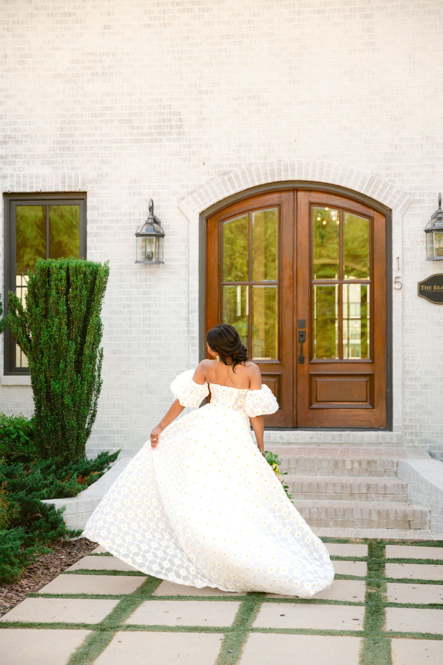 A sequence of photos showing a white wedding dress flowing across a paved walkway against a light brick house exterior.