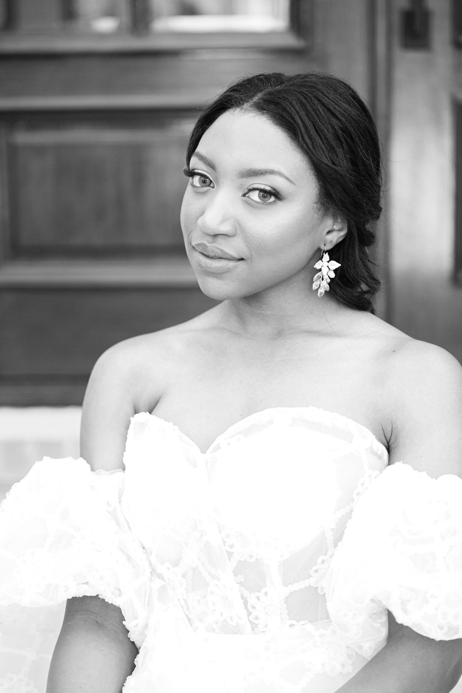 A series of black and white close-up photos showing a person in an elegant white lace wedding dress.