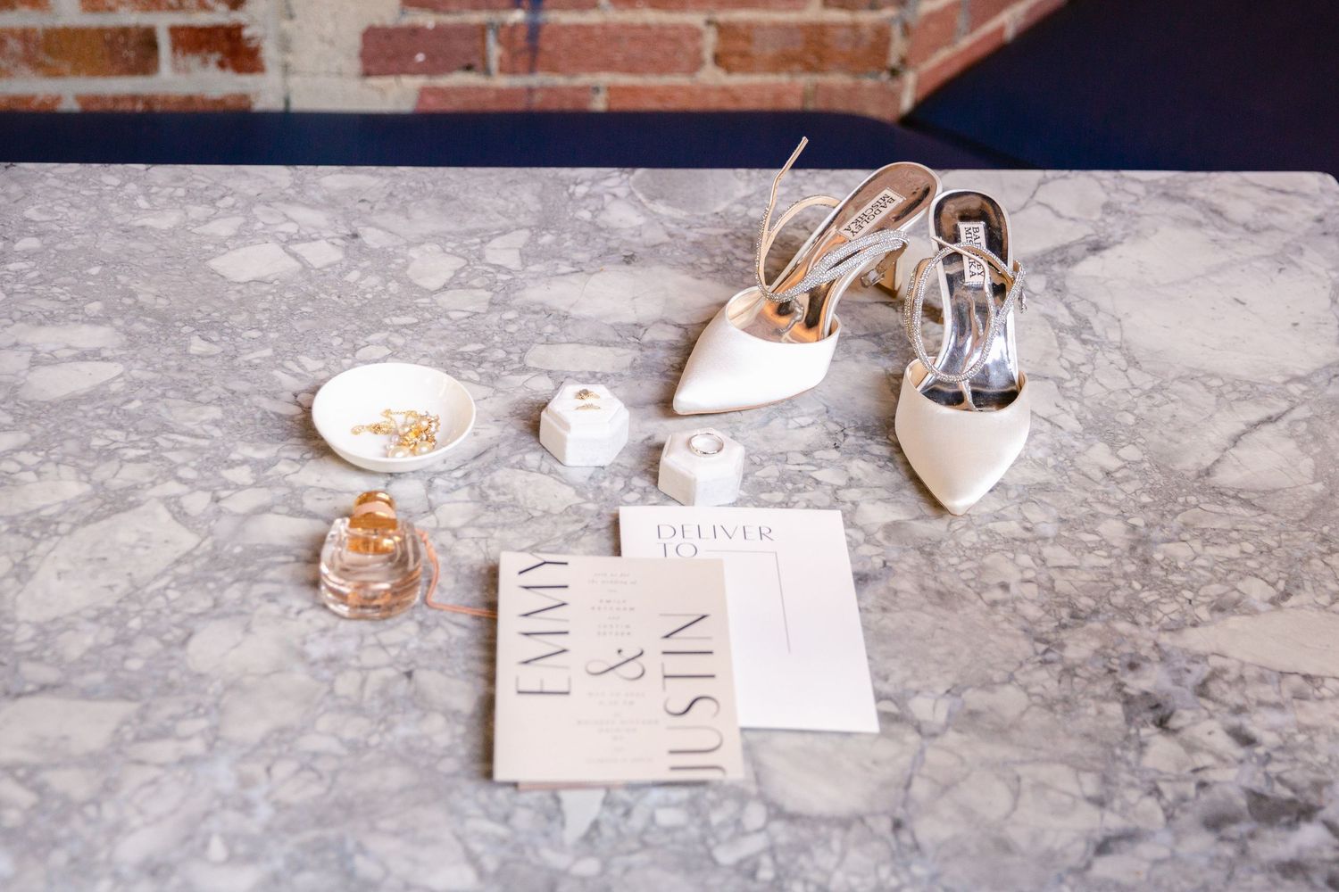 Rustic place settings with vintage glassware and handwritten cards on a weathered stone surface at an elegant event.