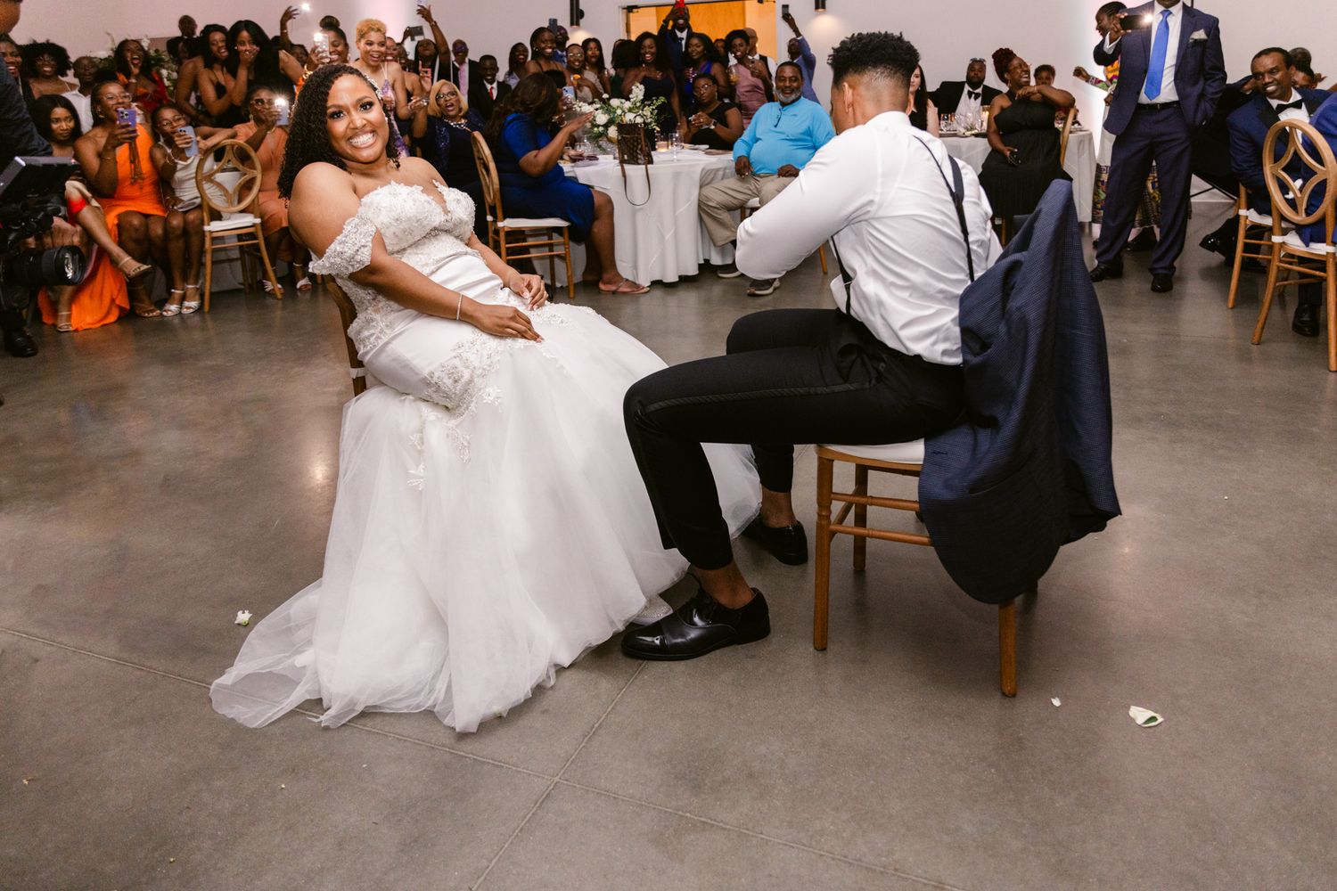 Wedding reception dance floor filled with celebrating guests in formal attire.