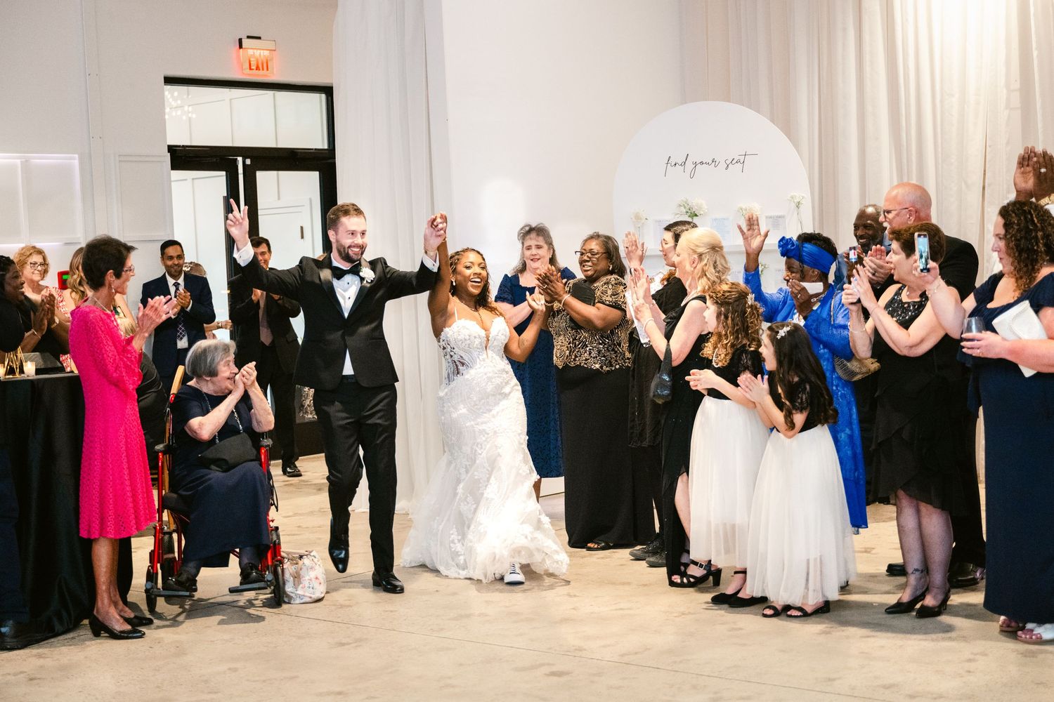 Wedding guests dance and celebrate on the dance floor during an elegant reception.