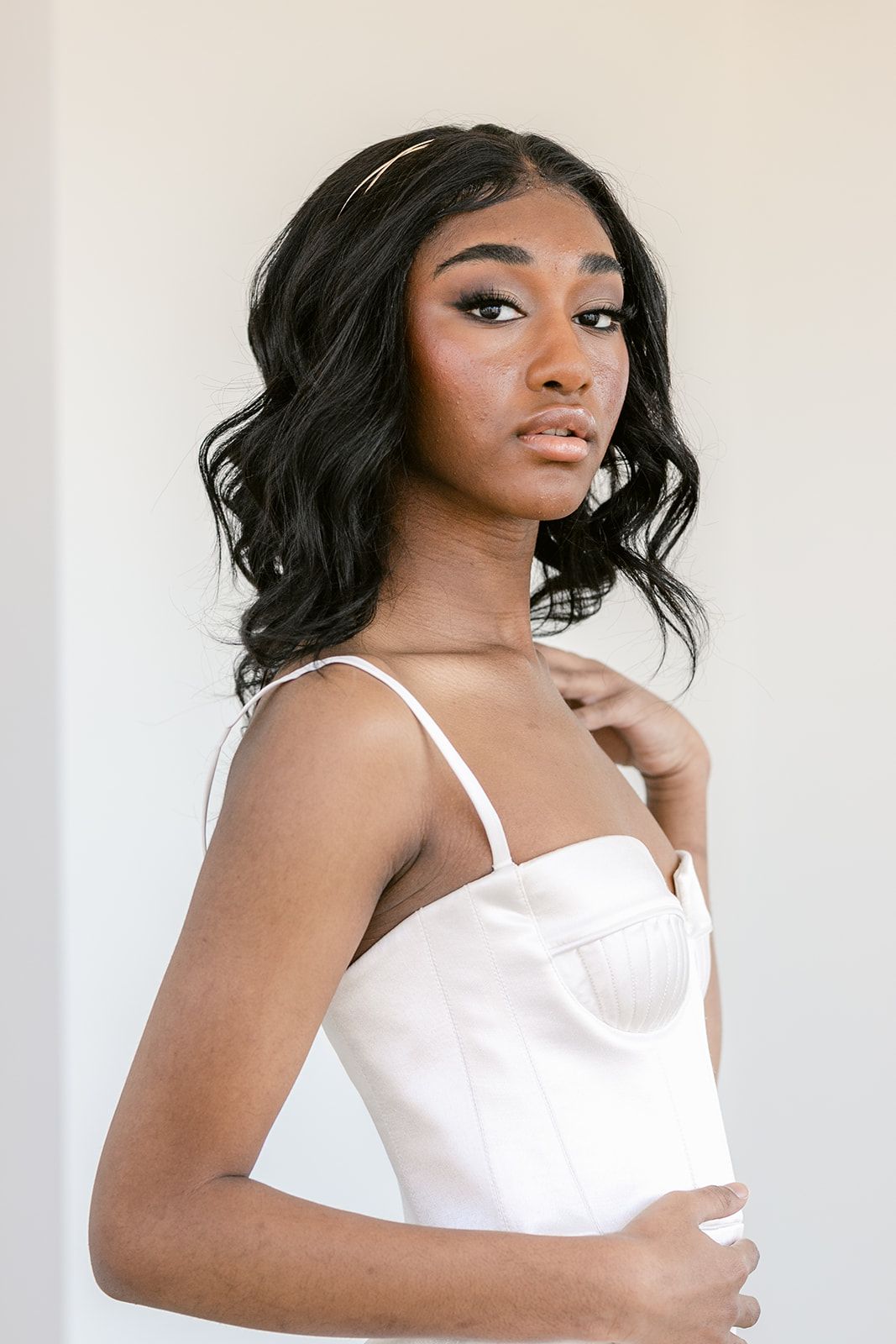 A series of glamour portraits showing a person in a white top against a light background.