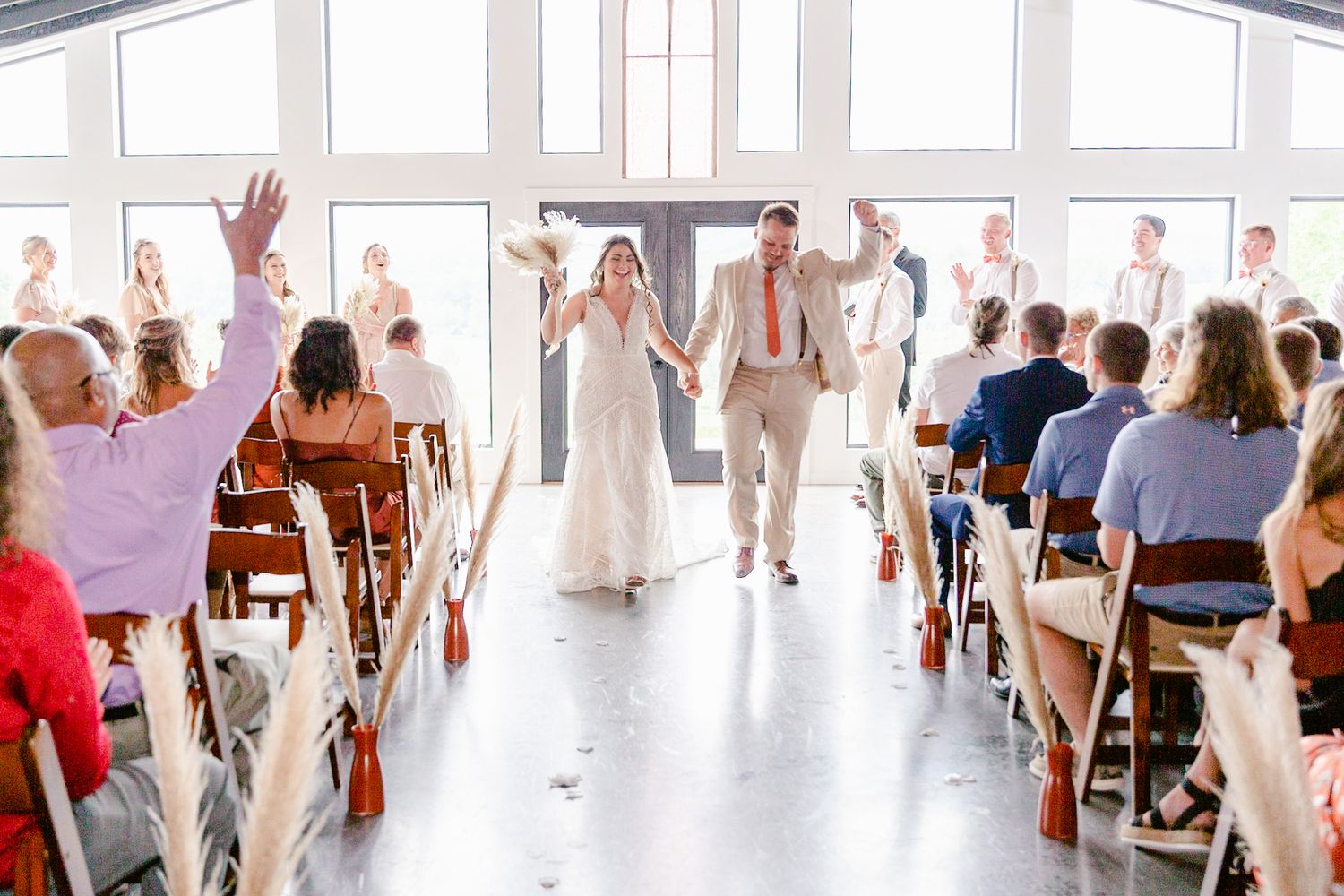 People dance together in a bright studio space with large windows and white walls during a dance class.