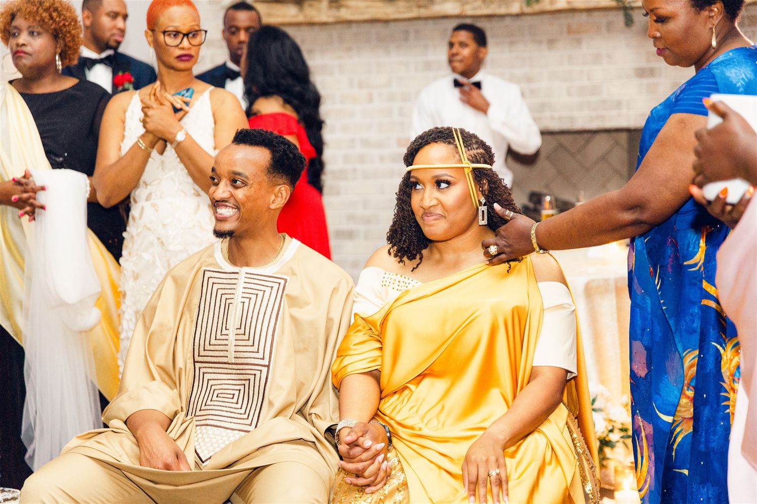 Wedding celebration with guests wearing coordinated yellow and blue formal attire.