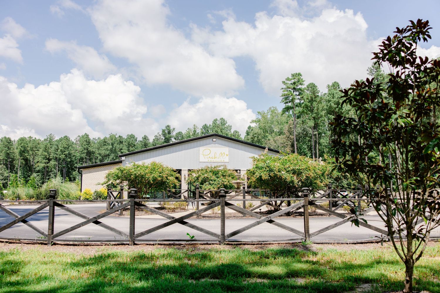 A panoramic view of a rural landscape with trees and buildings stretching across multiple connected images.
