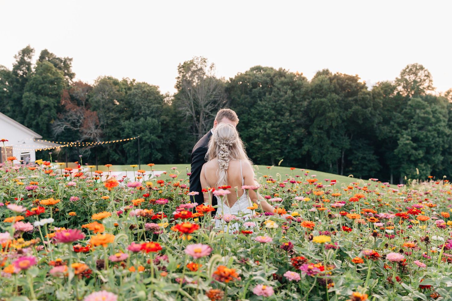 Wedding moment captured in a vibrant field of orange and red wildflowers.