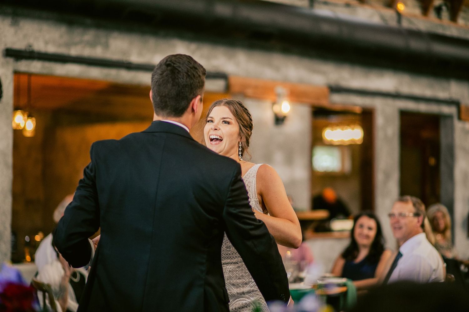 A couple shares an intimate dance moment at their wedding reception.