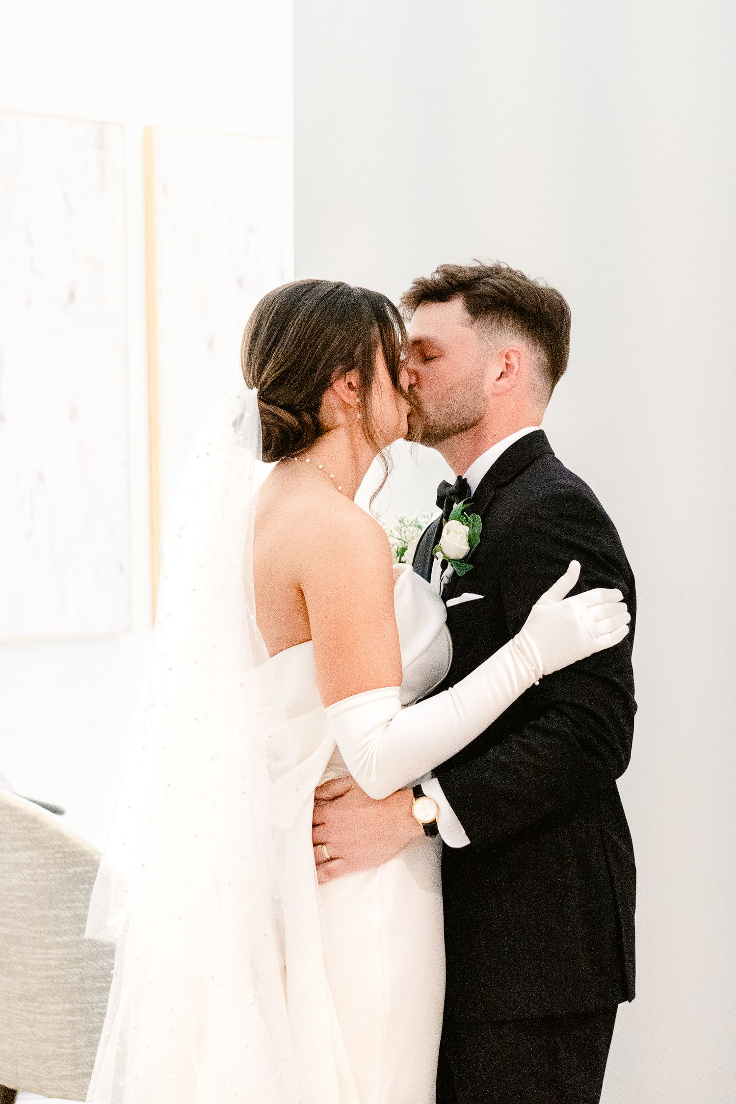 A tender moment captured during a wedding with the couple in classic black and white attire.