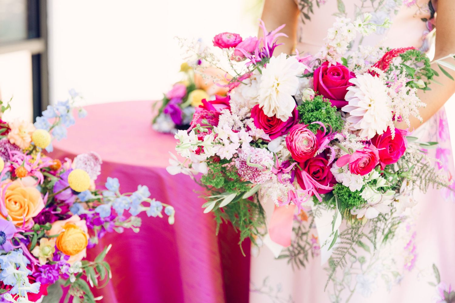 Lush floral arrangement featuring pink, purple, and white blooms with delicate greenery.