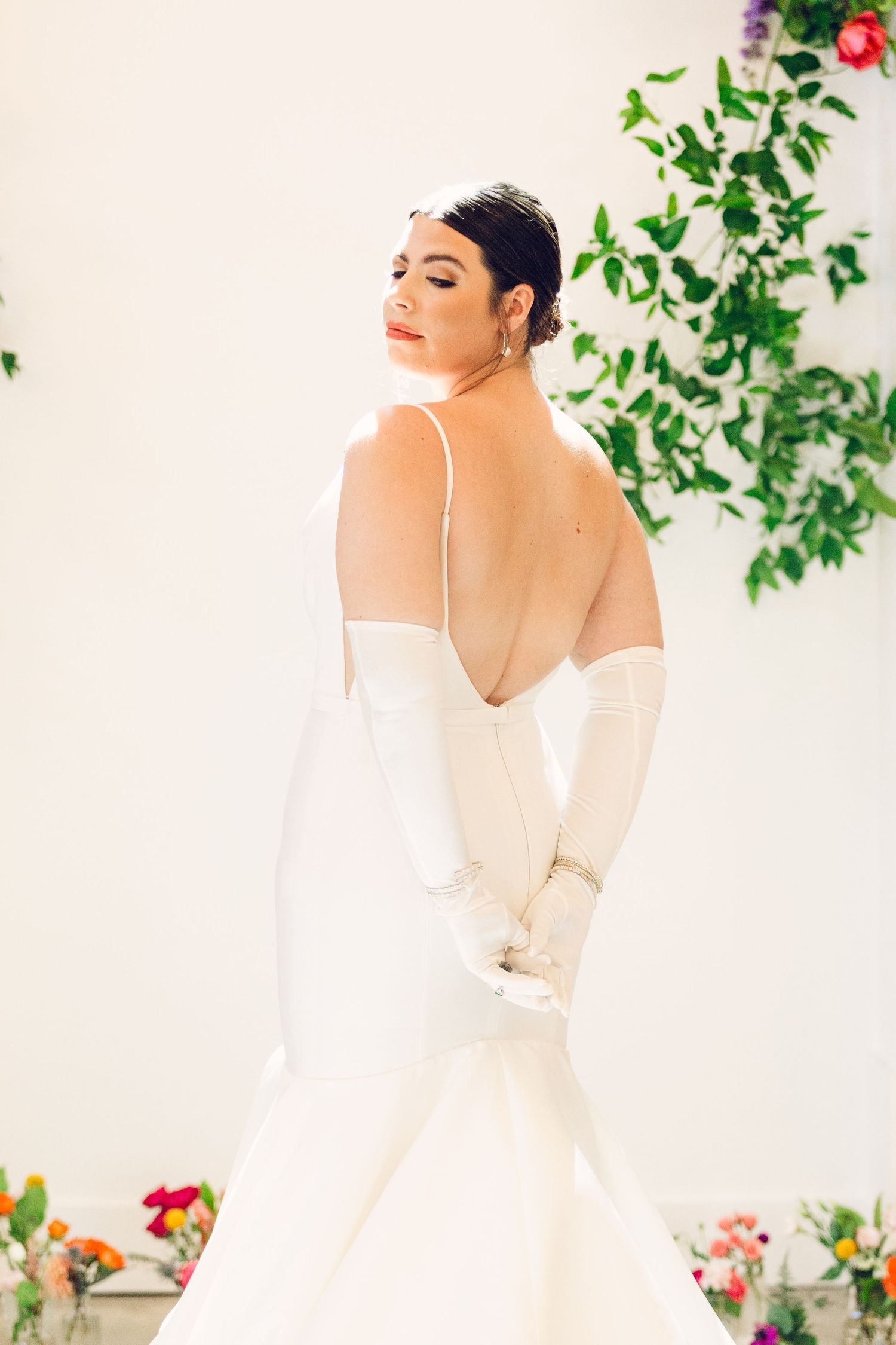 Wedding dress detail showing off romantic white fabric and delicate straps.
