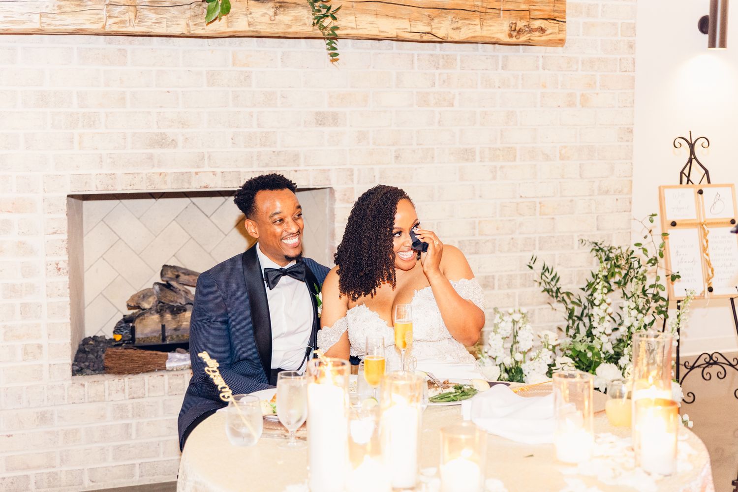 Modern wedding reception venue with exposed brick walls and hanging greenery.