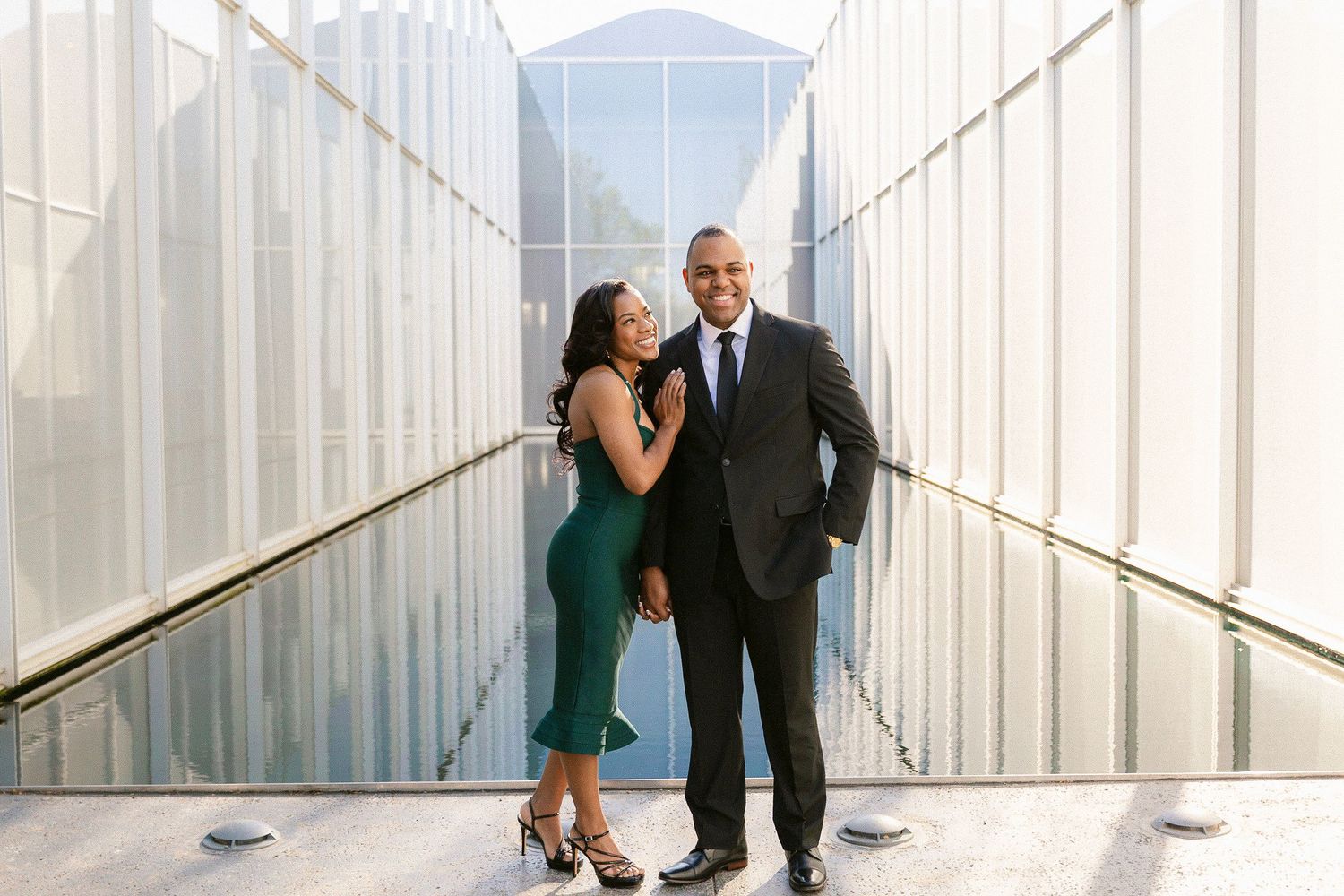 A couple shares intimate moments in a series of candid shots against a white industrial backdrop.