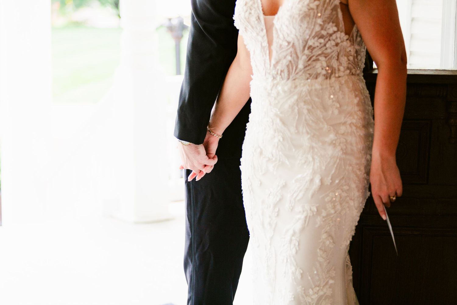 A wedding couple stands together in formal attire during their special day celebration.