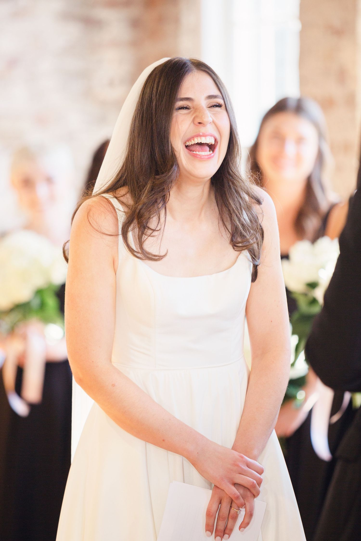 Candid moment of joyful laughter during wedding preparations.