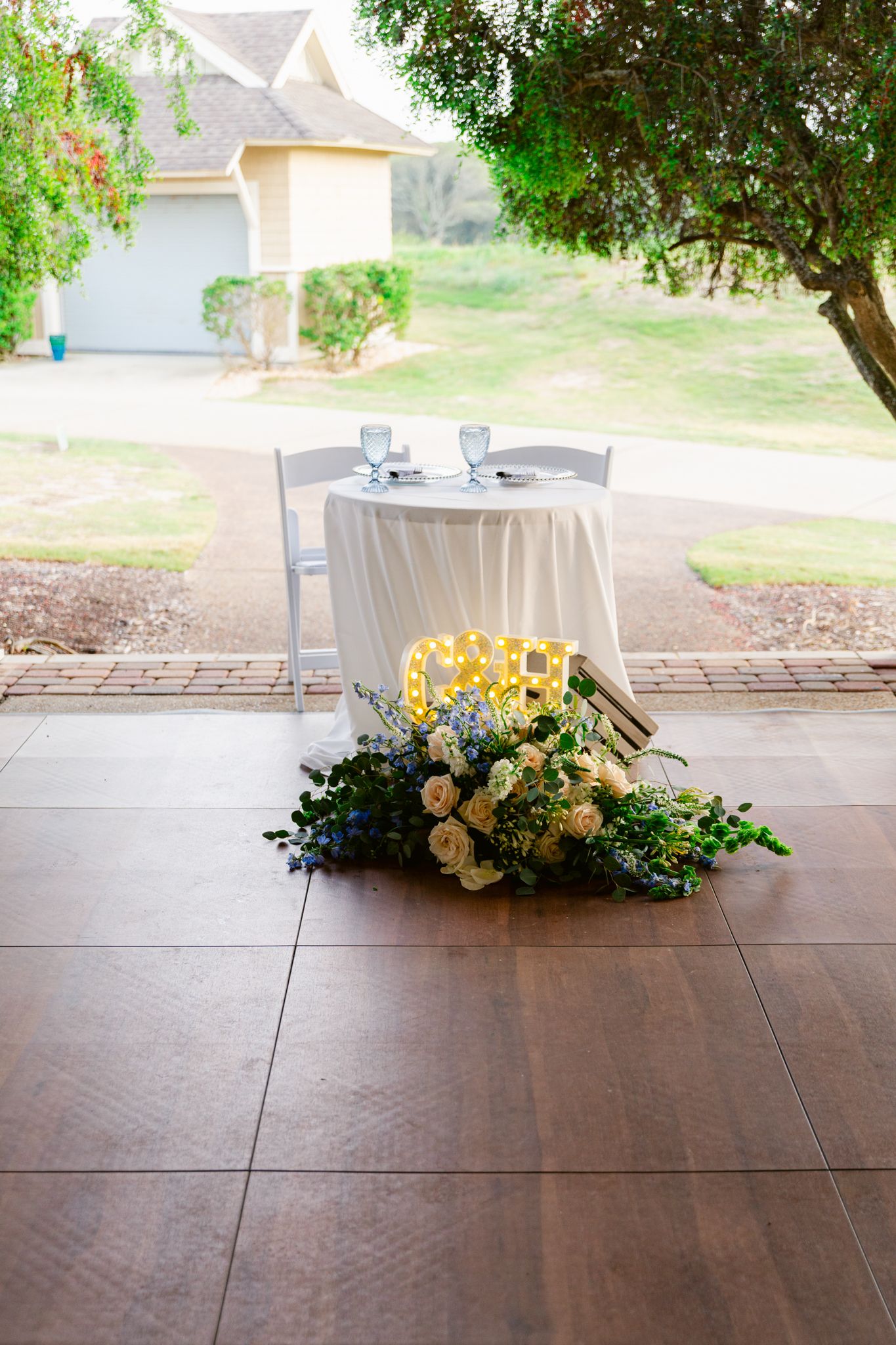 A sequence of four floral arrangements with yellow and peach flowers on a dark wooden surface.