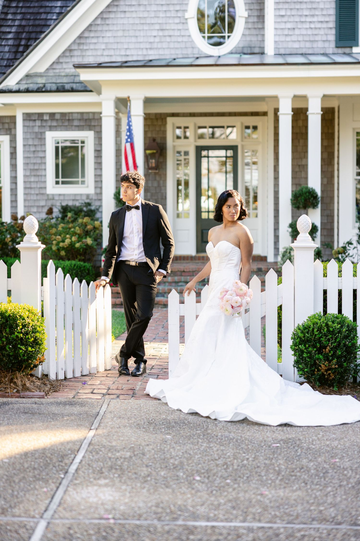 Series of photos showing a bride and groom walking along a white picket fence at an elegant venue.
