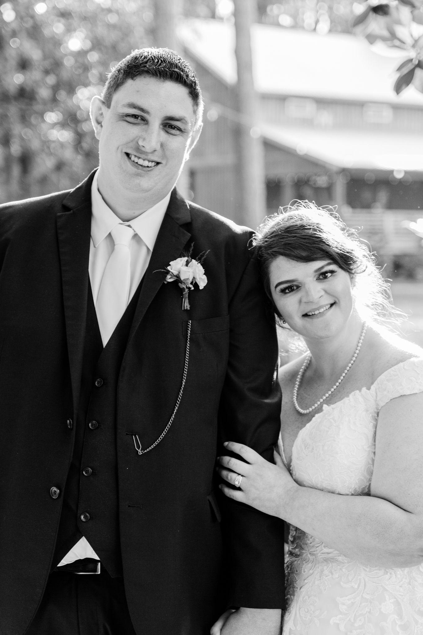 Black and white wedding portraits showing joyful moments between newlyweds outdoors.