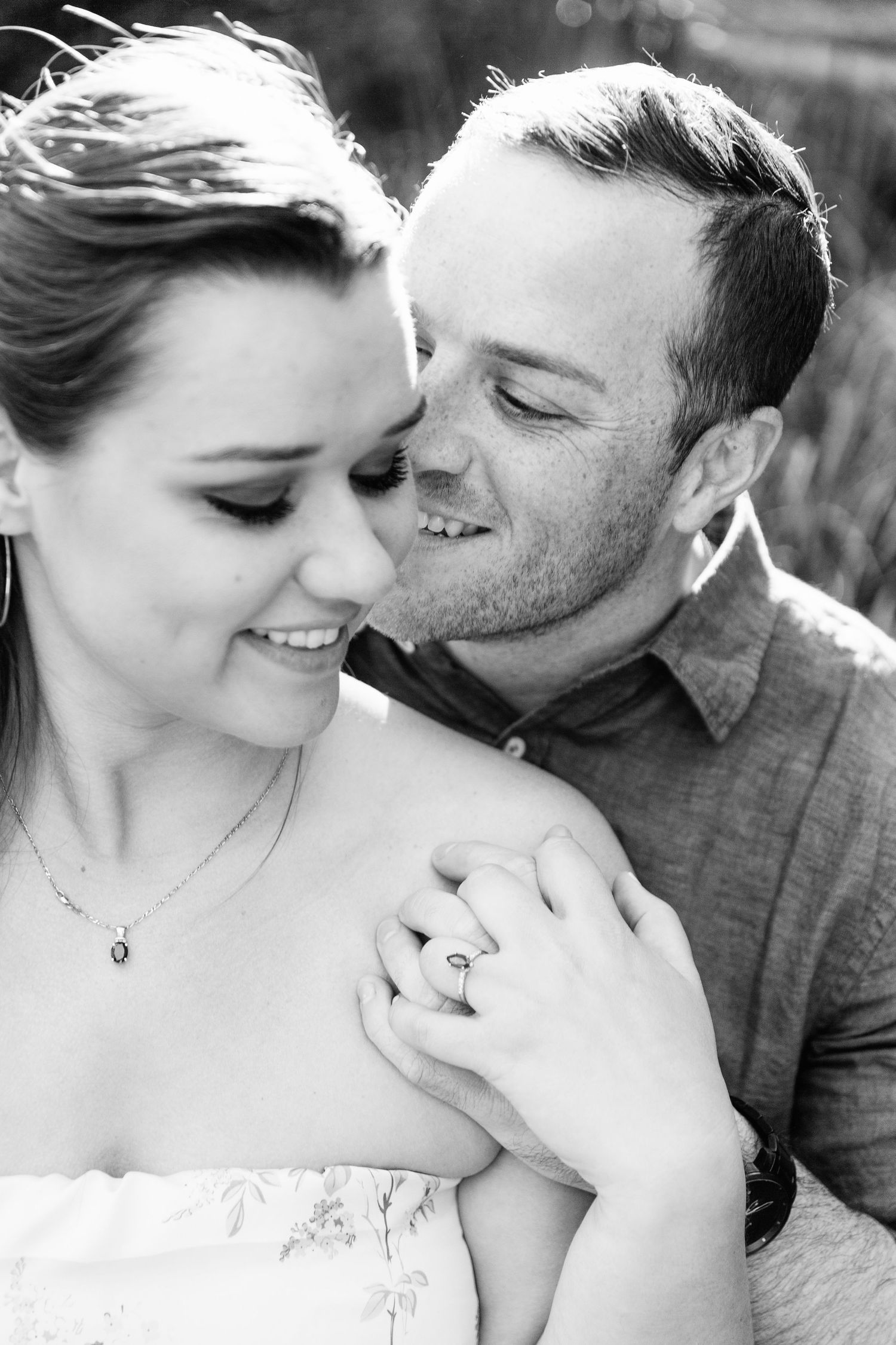 Romantic black and white engagement photo series showing tender moments between a couple.