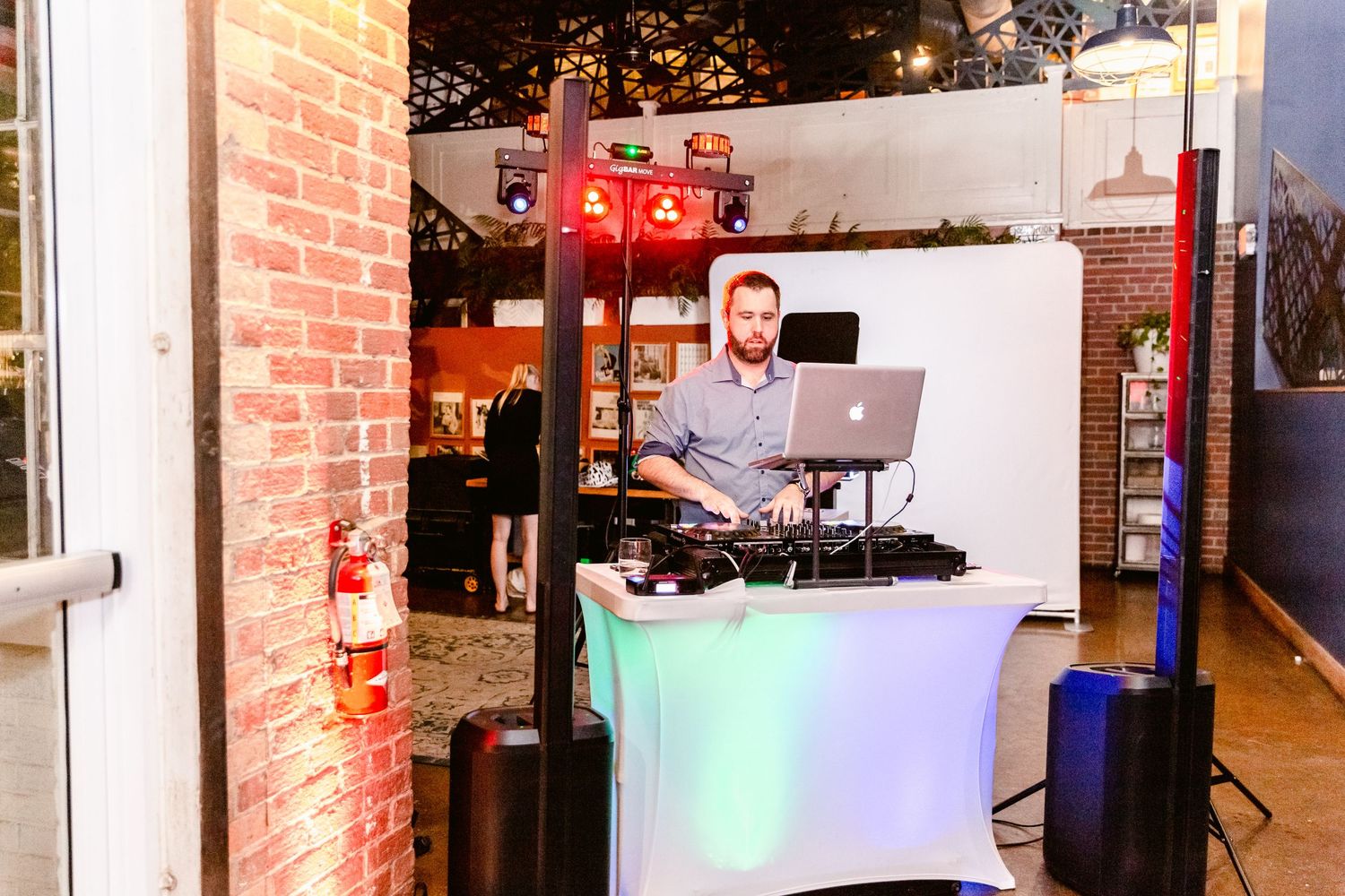 Wedding venue interior with exposed brick walls and decorative lighting creates an industrial chic atmosphere.