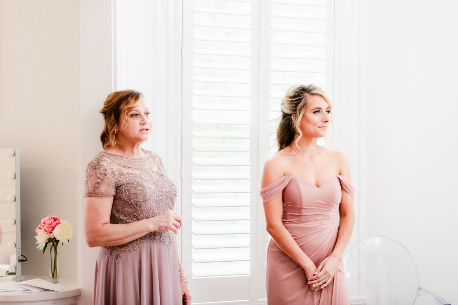 A series of soft pink bridesmaids dresses shown in a collage of elegant wedding party photos.