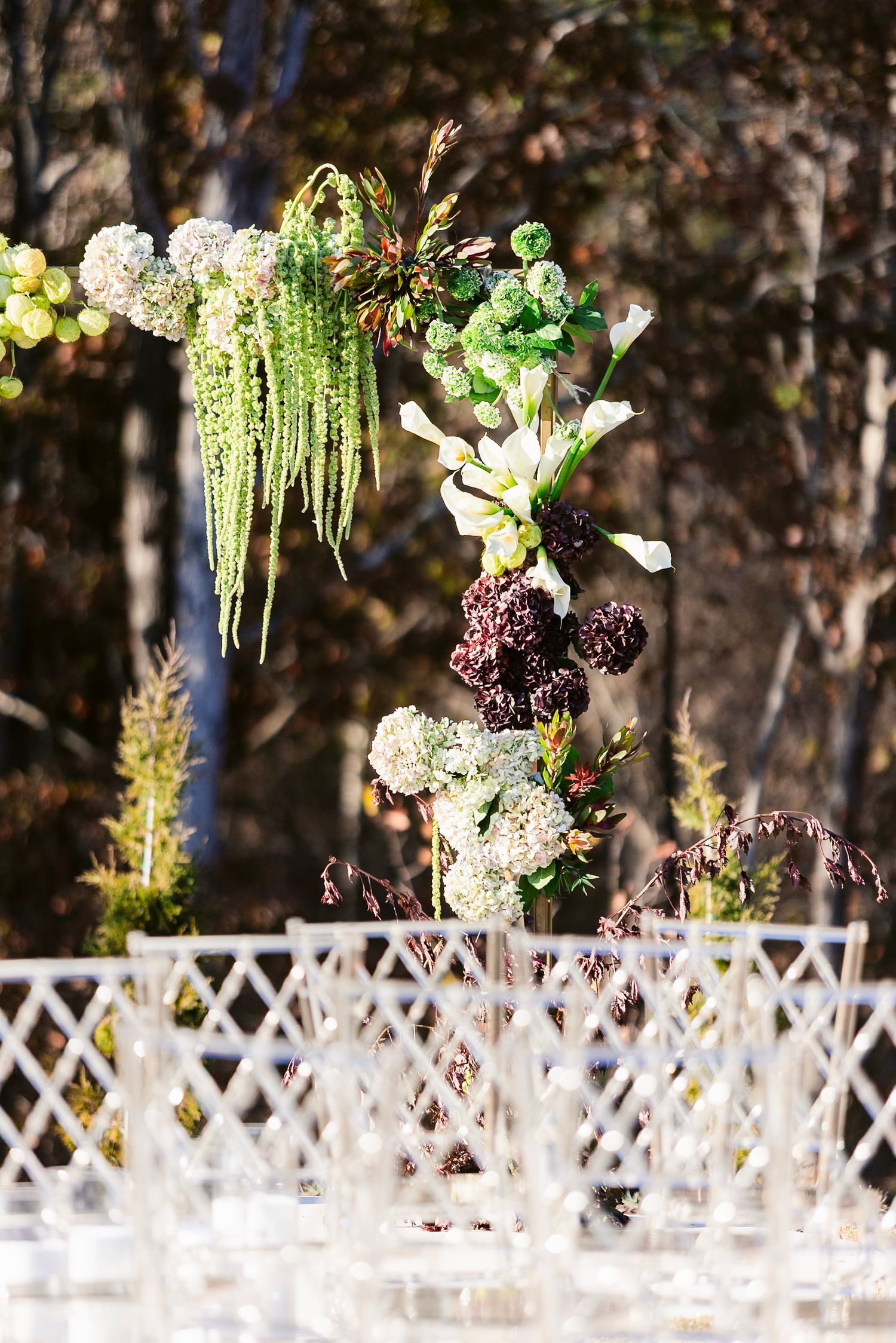 Crystal icicles and dried floral arrangements create an elegant winter wedding decor display against a dark background.