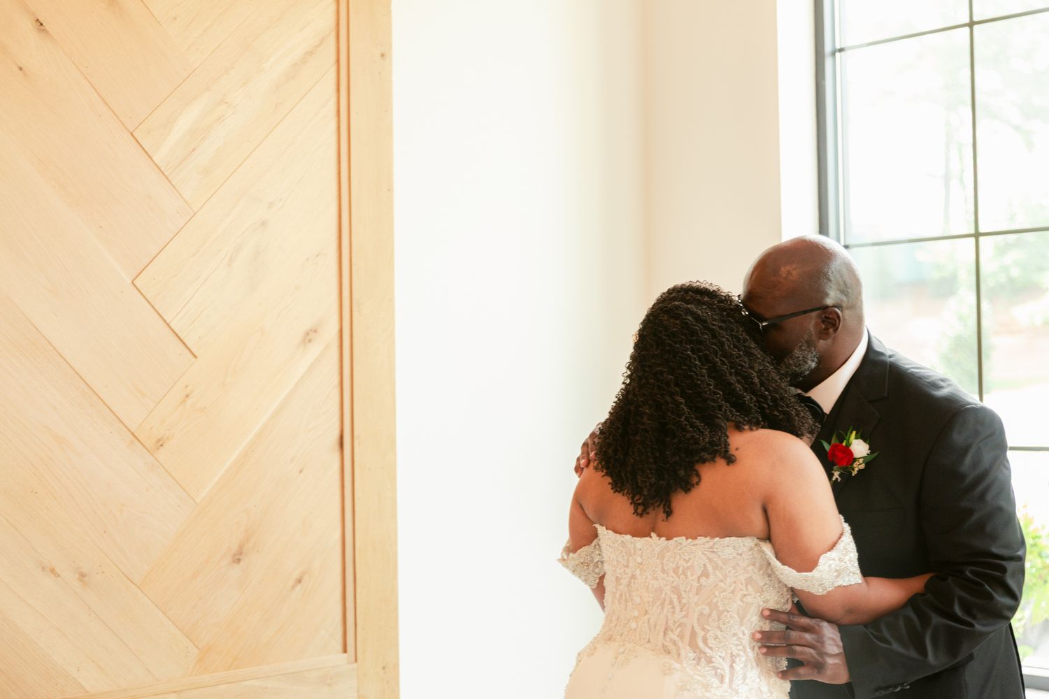 Emotional wedding ceremony moments showing embraces between the wedding party members in formal attire.