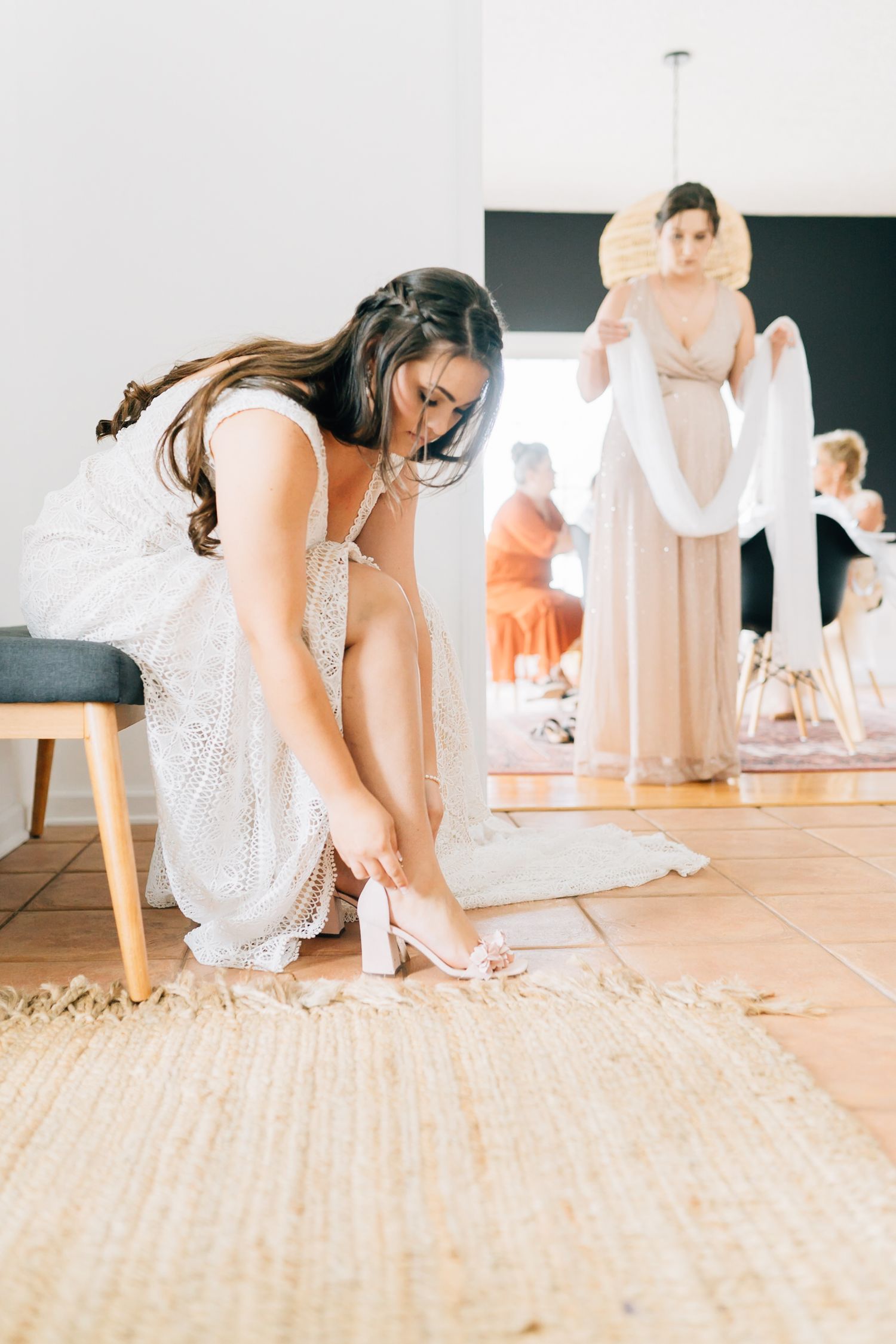 Series of shots showing sparkly wedding shoes being put on against a light wooden floor.