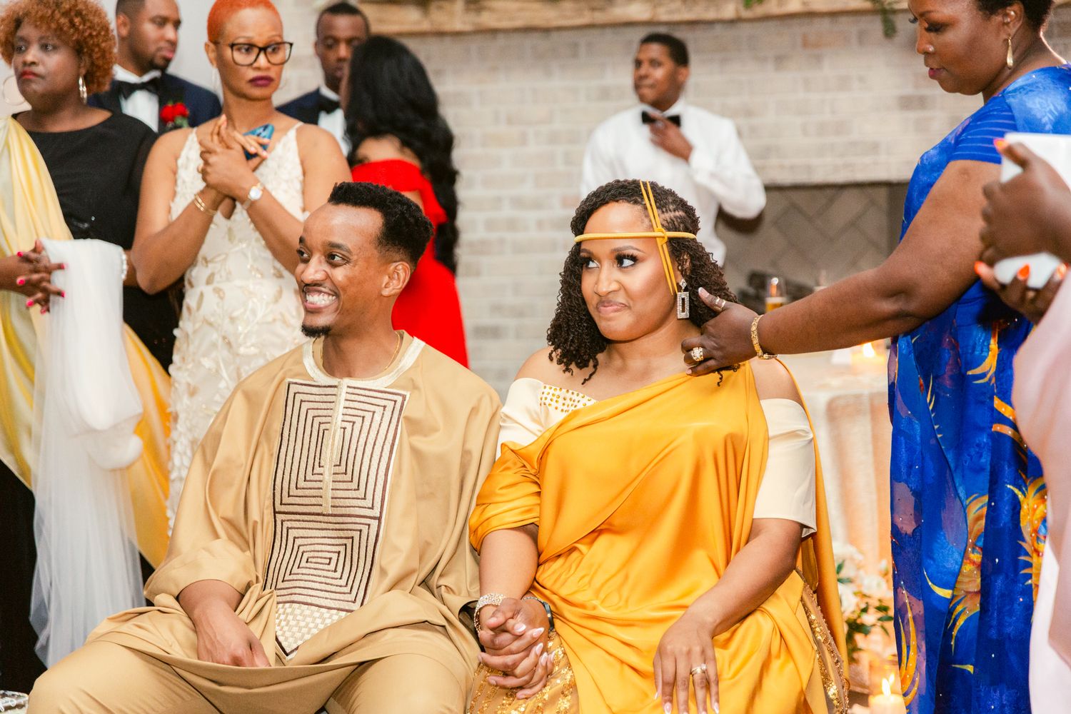 Wedding party members wearing vibrant yellow and blue traditional formal attire.