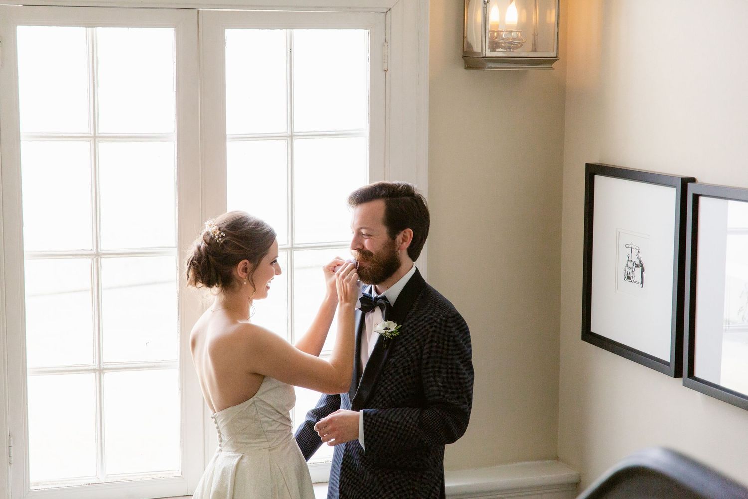 Sunlit wedding venue interior with large windows and elegant decor.