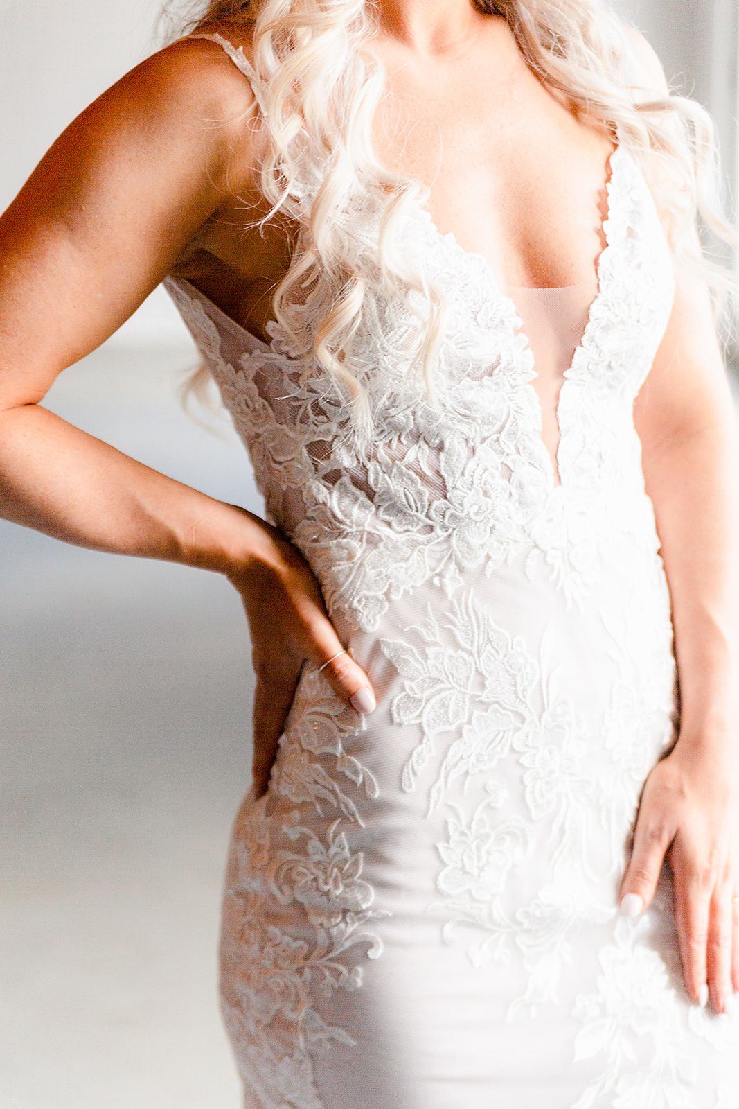 Close-up detail of intricate lace bodice on white wedding gown.