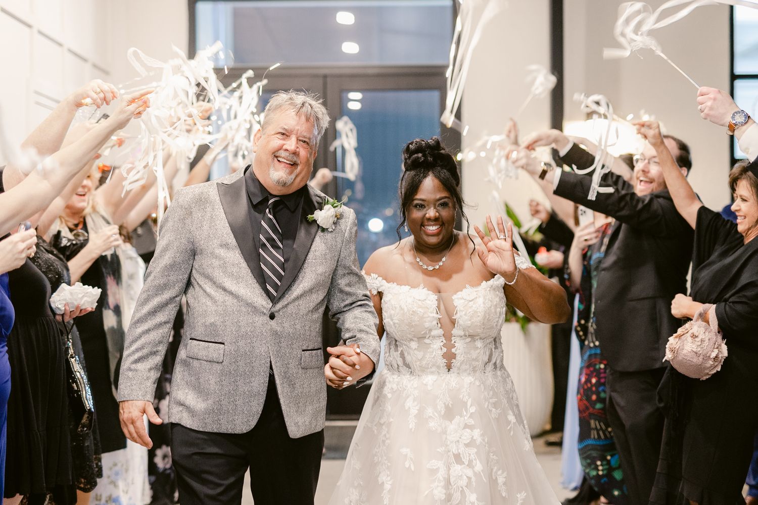 Wedding party celebrates with confetti and joyful expressions in an indoor venue during reception festivities.