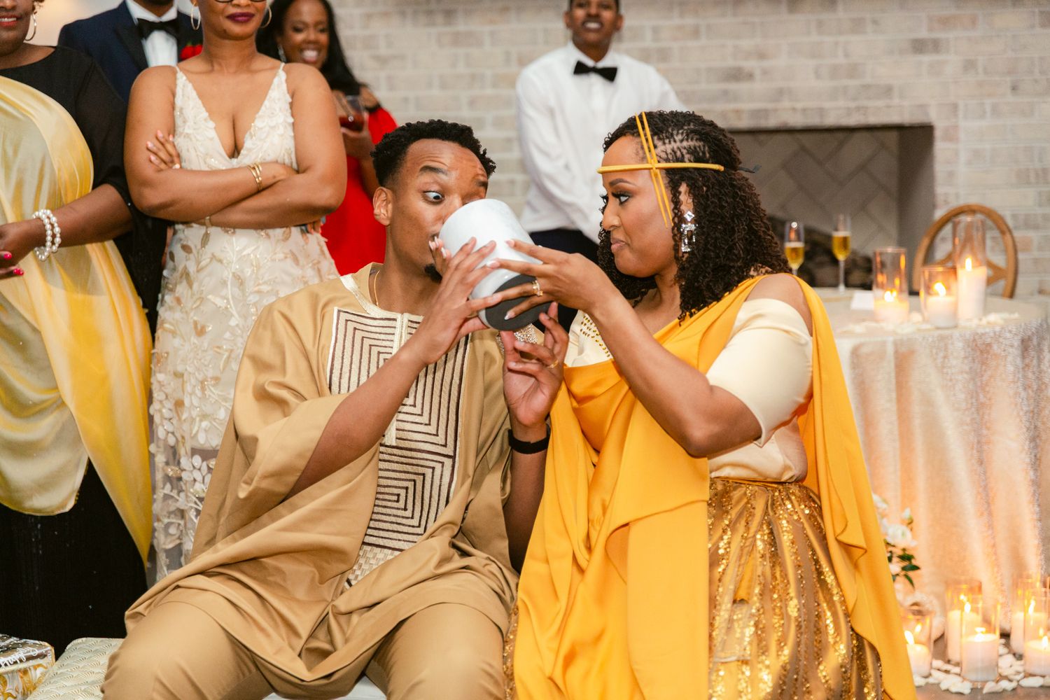 Wedding party members in yellow dresses sharing joyful moments at the reception.